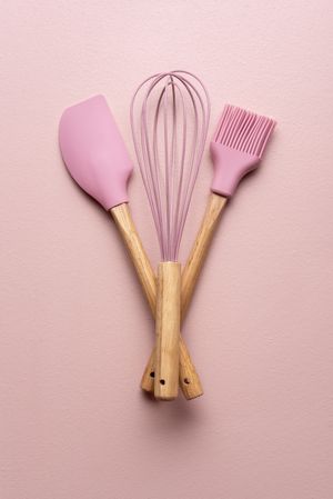Pink baking utensils on a pink table