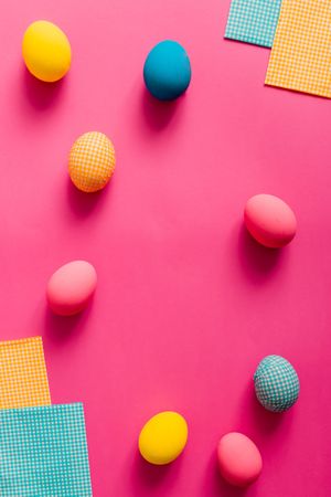 Colorful Easter eggs on pink paper