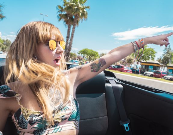 Young woman riding cabriolet