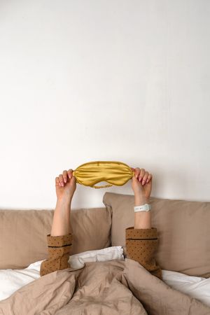 Hands up with sleep mask and smartwatch