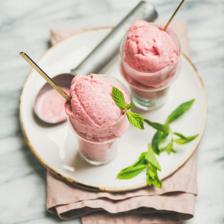 Homemade strawberry yogurt ice cream with fresh mint, square crop