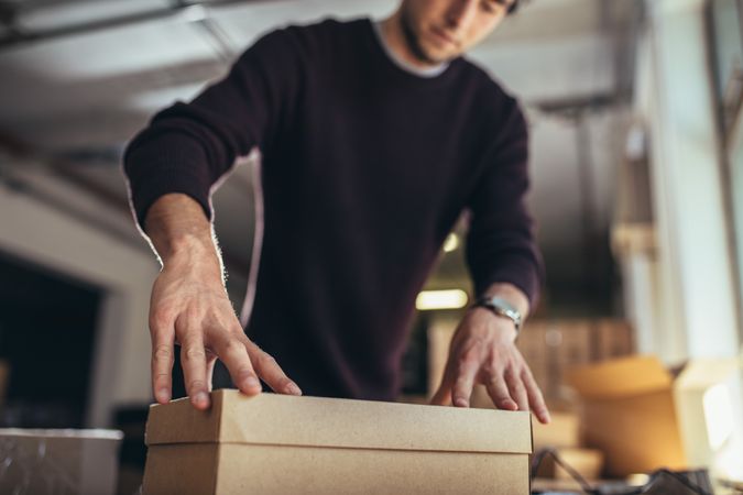 Small business owner packing in the box for shipping