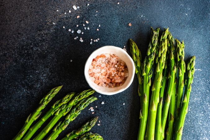 Raw asparagus on counter with Himalayan salt