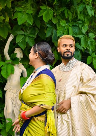 Indian man and woman in traditional festive outfit standing outdoor