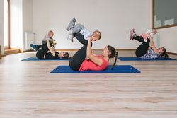 Mothers exercising with babies in gym