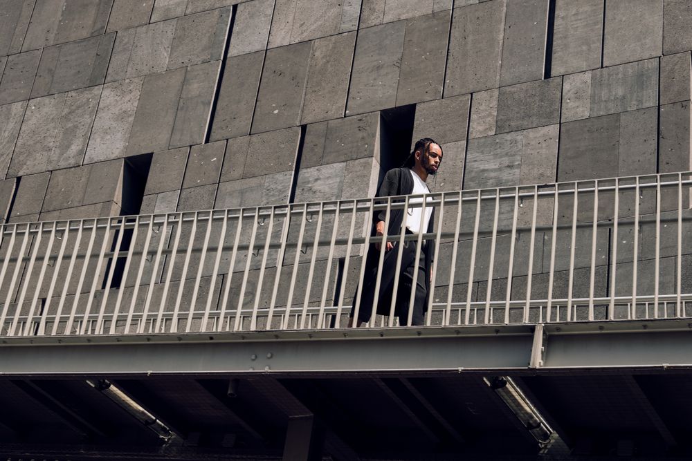 Black male walking on bridge