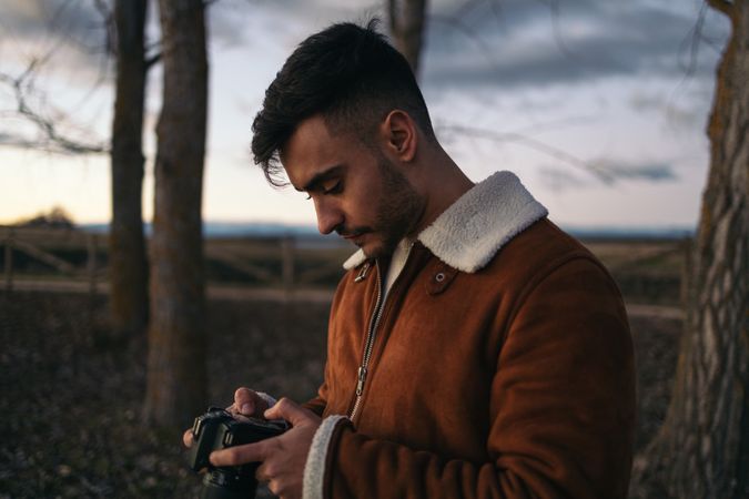 Portrait of a photographer taking photos in the countryside