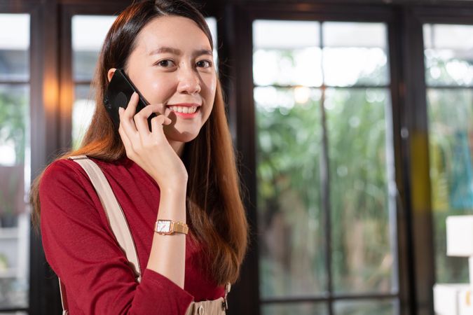 Smiling Asian woman on phone