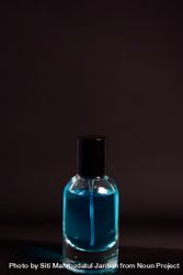 Light blue perfume bottle in grey studio with copy space 4Bam6k