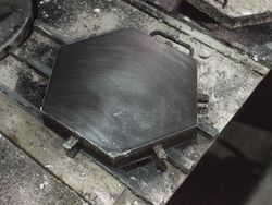 Metal mold for making hexagonal tile on table
