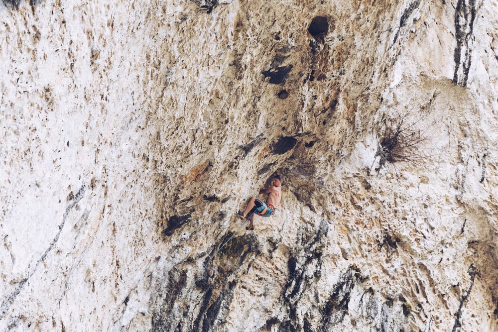 Anonymous man climbing rock