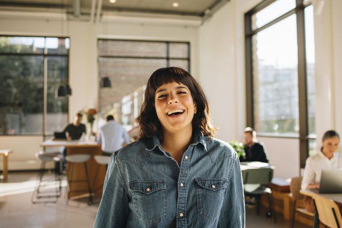 Smiling female freelancer in co-working space