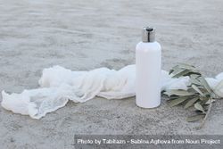 Cosmetic plastic bottle mockup with green olive tree branch and muslin cloth 4267Nx