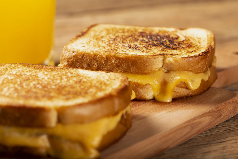 Grilled ham and cheese. Sandwich with cheese and ham on grill.