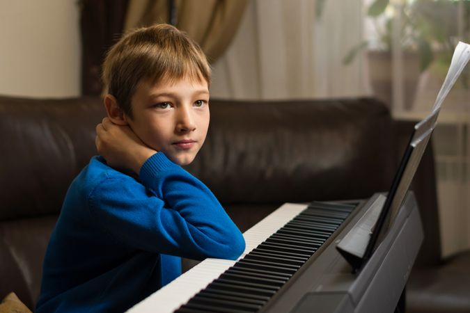 Thoughtful Boy with Piano