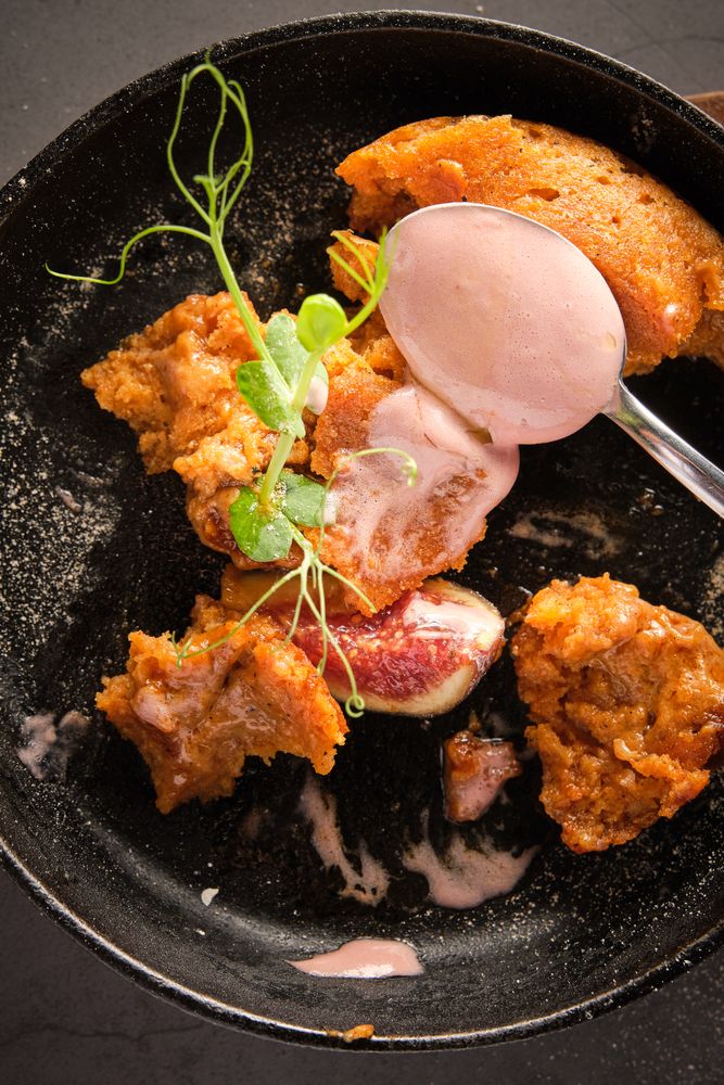 Appetizing cake with fig served with spoon