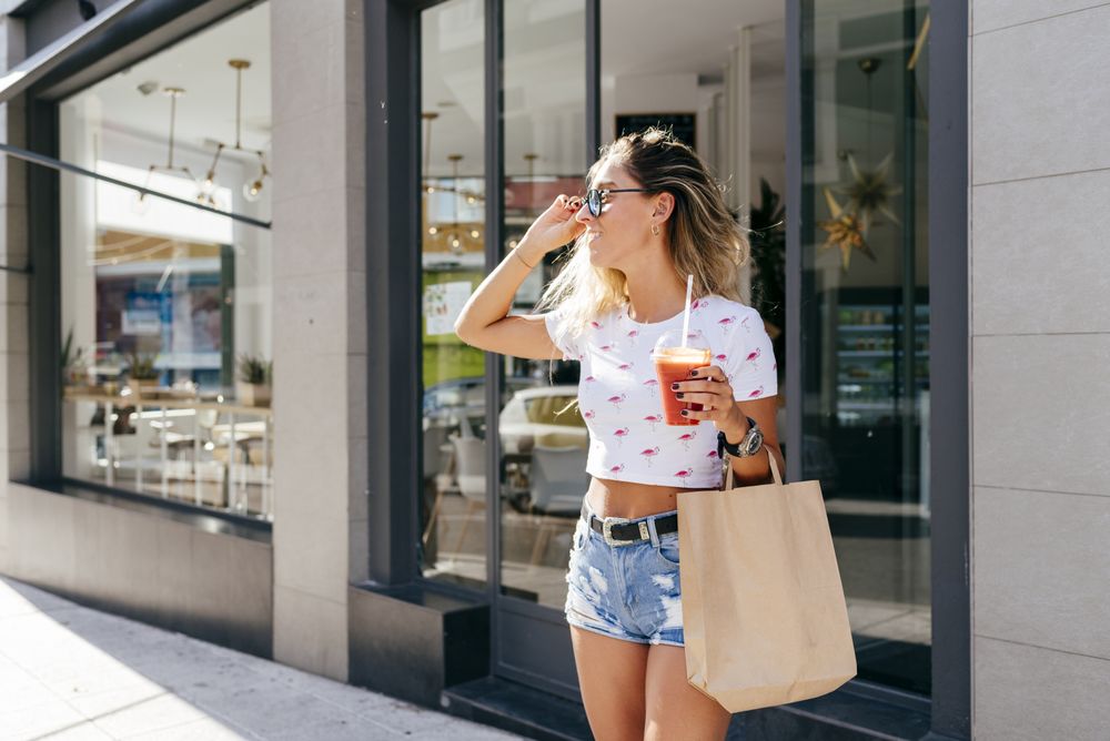 Cheerful woman leaving restaurant
