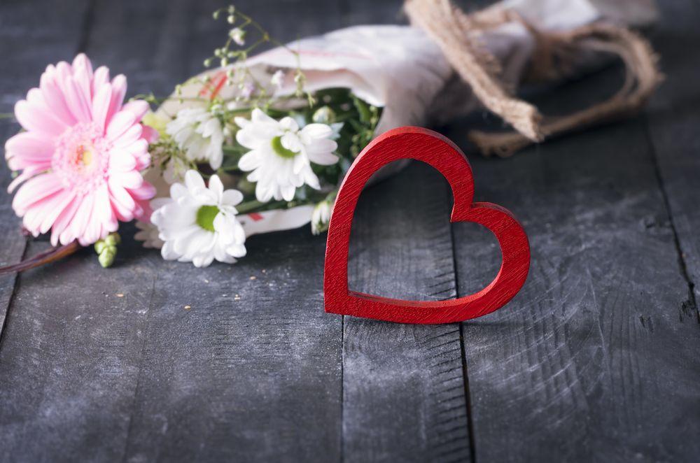 Bright red heart and a bouquet of flowers