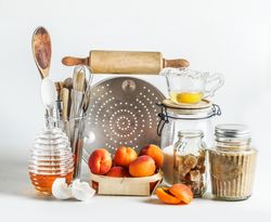 Baking setting with apricots, kitchen utensils, tools, honey and ingredients. Baking with seasonal fruit at home. Front view.