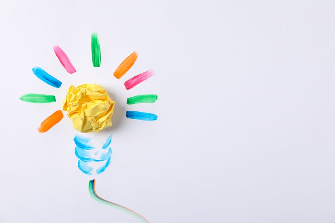 Drawn light bulb and paper ball on blank background, space for text
