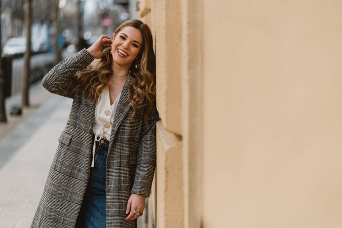 Woman leaning on wall on street