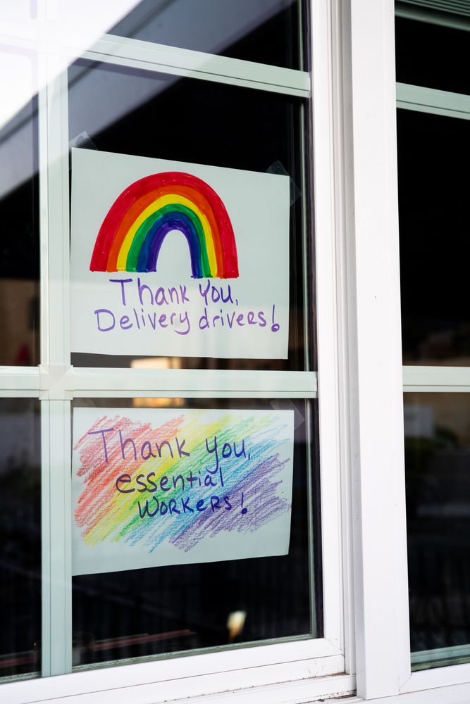 Close up of two handmade signs showing gratitude to essential workers during quarantine