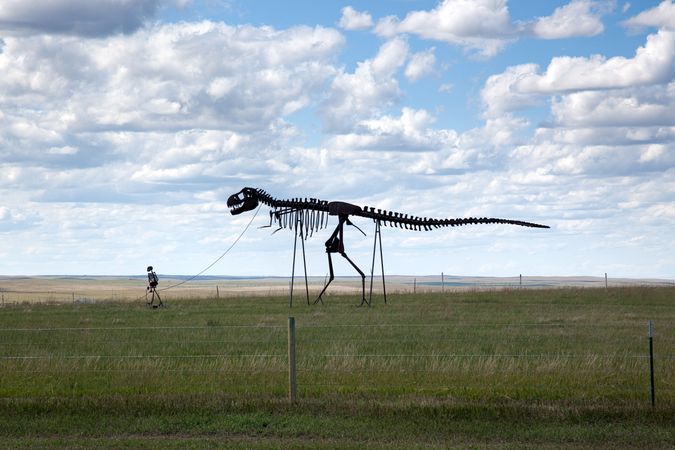 Roadside sculpture of a skeleton taking a dinosaur skeleton for a walk, South Dakota