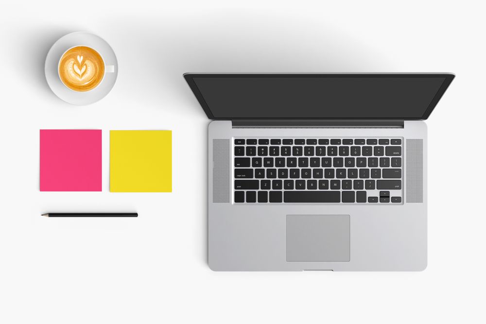 Modern workspace with coffee cup, smartphone, paper, notebook, tablet and laptop copy space