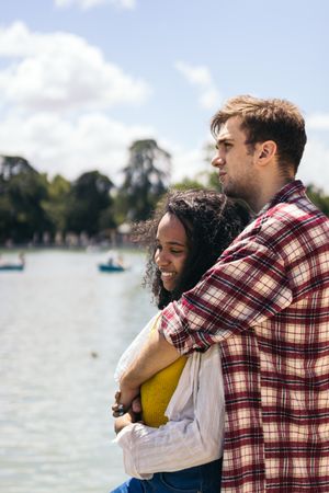 Interracial couple on a romantic date by a beautiful lake