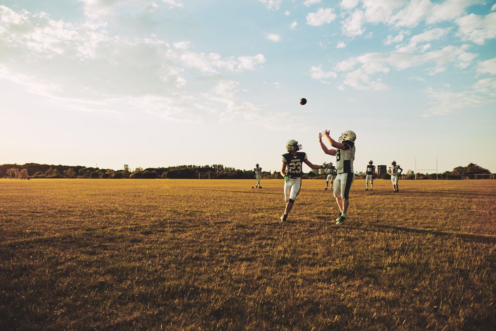 Man catching football during practice