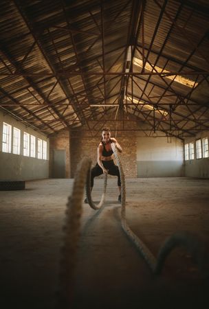 Athlete working out with battle rope