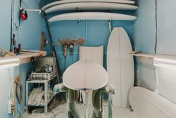 Workshop with surf boards near different tools