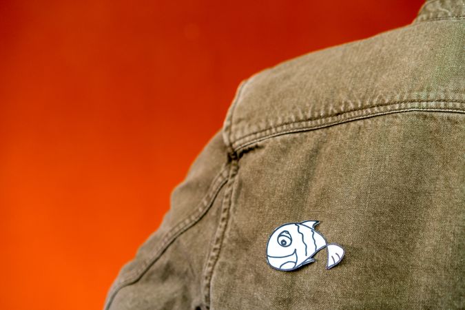 man with funny paper toy on jean jacket