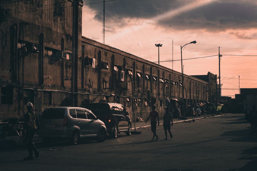 People walking down the street at sunset