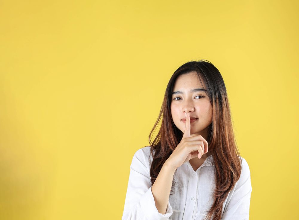 Young Woman Say Hush Be Quiet with Finger on Lips Shhh Gesture