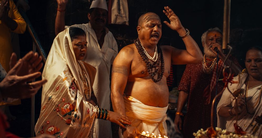 Close Up Portrait of Old Indian Monk Chanting in an Ancient Temple.