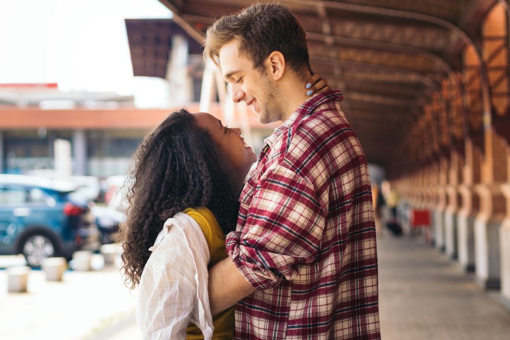 Cute couple meeting at the station after a trip