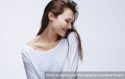 Beautiful woman in white top smiling 56GD7L