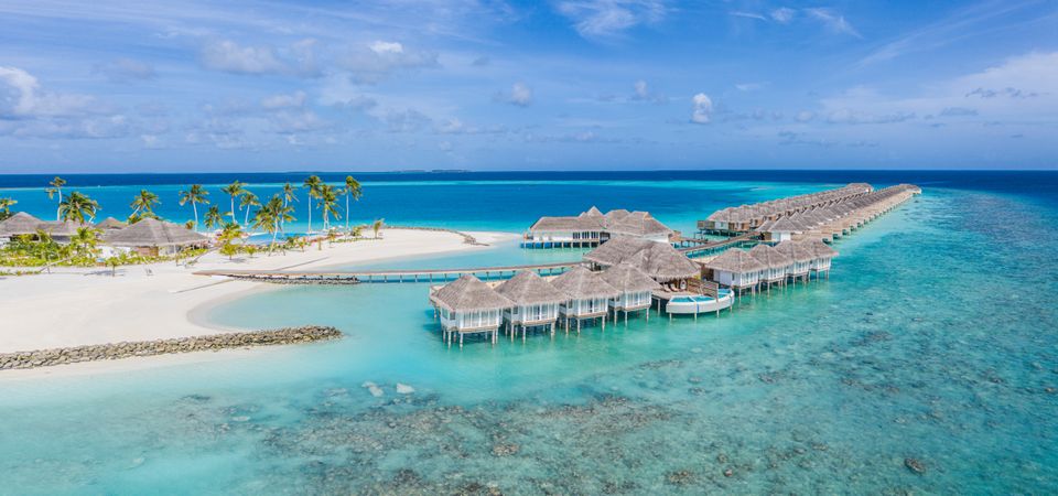 Overwater bungalows in a Maldives beach resort, wide shot
