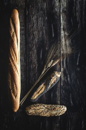Assorted gold homemade bread on dark wood background