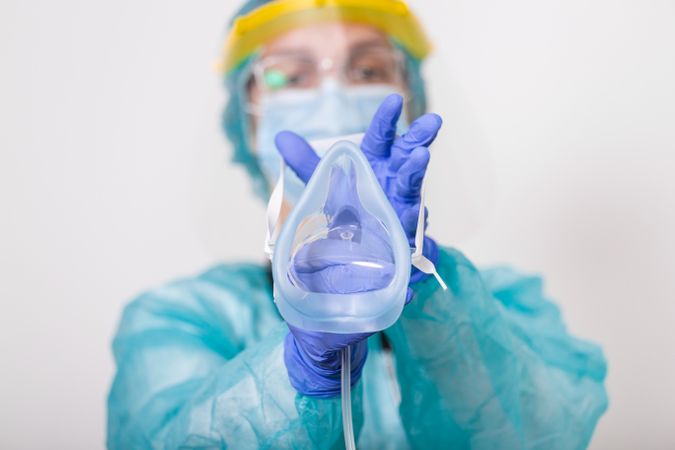 Healthcare worker holding oxygen mask