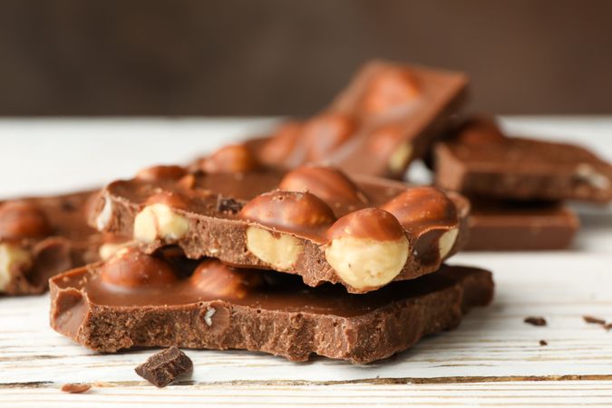 Tasty chocolate pieces on wooden table