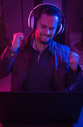 Man listening cheerfully to music with headphones.