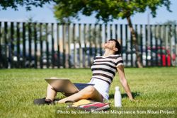 Woman sitting in park with computer 4AzKNN