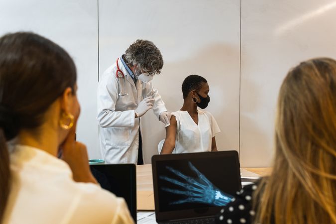 Doctor injecting patient