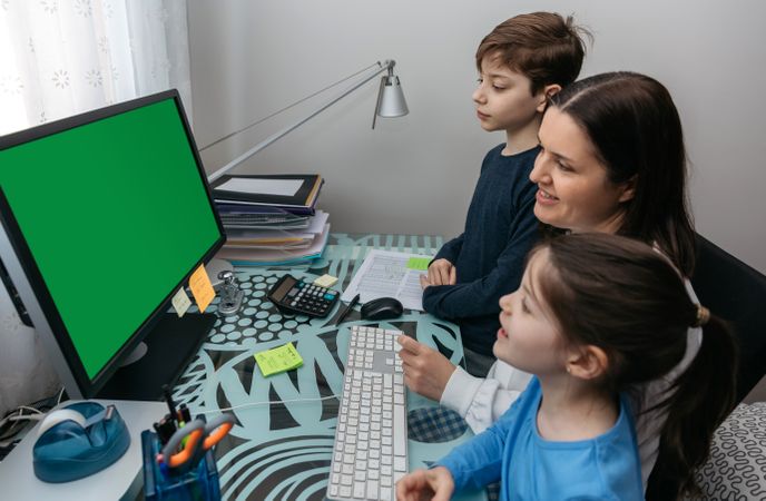 Mother and children looking at computer screen