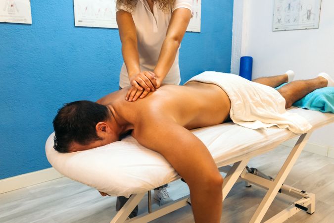 Physiotherapist woman treating a male patient