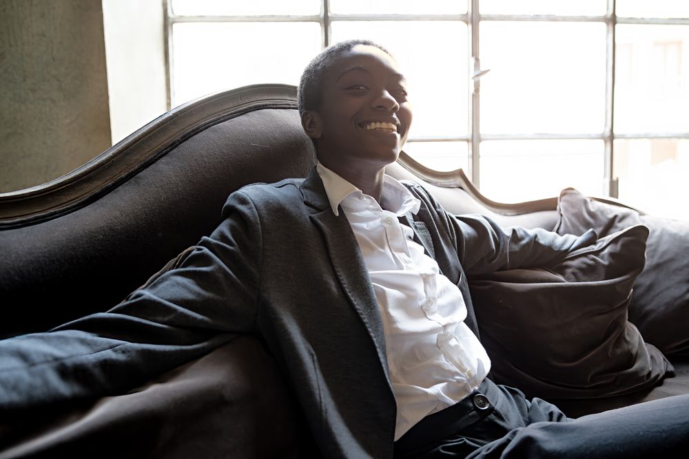 Professional Black woman enjoying a break in a modern office