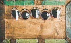 Glasses of red wine glasses laying on wooden background, with copy space