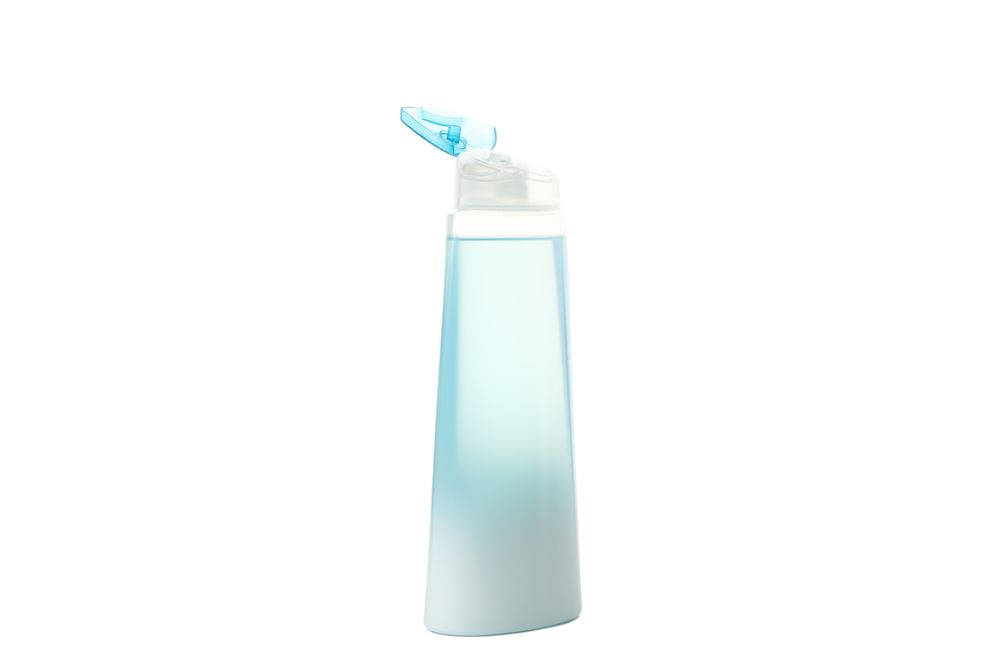 Blank plastic shampoo or lotion bottle isolated on light background